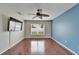 Bright living room featuring hardwood floors, a ceiling fan, and large window at 15406 Peach Stone Pl, Ruskin, FL 33573
