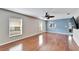 Spacious living room featuring hardwood floors and ceiling fan at 15406 Peach Stone Pl, Ruskin, FL 33573