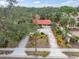 Single story home with red tile roof, brick driveway & lush landscaping at 1545 Park N St, St Petersburg, FL 33710