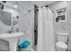 Clean bathroom with white pedestal sink and shower at 1545 Park N St, St Petersburg, FL 33710