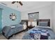 Bedroom with twin beds, light blue wall, and ceiling fan at 1545 Park N St, St Petersburg, FL 33710