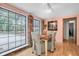 Bright dining area with large windows, wooden table, and brick accent wall at 1545 Park N St, St Petersburg, FL 33710