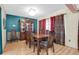 Formal dining room with wood table and chairs, hardwood floors, and teal accent wall at 1545 Park N St, St Petersburg, FL 33710