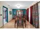 Formal dining room with wood table and chairs, teal walls, and hardwood floors at 1545 Park N St, St Petersburg, FL 33710