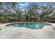 Inviting kidney-shaped pool surrounded by brick decking in a shaded backyard at 1545 Park N St, St Petersburg, FL 33710