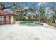 Kidney shaped pool with brick coping and surrounding patio at 1545 Park N St, St Petersburg, FL 33710