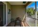 Relaxing screened balcony with seating area and view of lush greenery at 1563 Mac Chesney Dr, Tarpon Springs, FL 34689