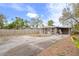 House with backyard, paved area, and covered carport at 1642 49Th N Ave, St Petersburg, FL 33714