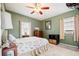Bedroom with full-size bed, ceiling fan, and green walls at 1642 49Th N Ave, St Petersburg, FL 33714