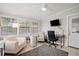 Bright sunroom with seating, workspace, and ceiling fan at 1642 49Th N Ave, St Petersburg, FL 33714
