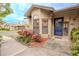 Villa front door entrance with well manicured landscaping at 1673 Nash Ct, Dunedin, FL 34698