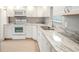 Modern kitchen with white cabinets and granite countertops at 1673 Nash Ct, Dunedin, FL 34698