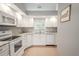Modern kitchen featuring white cabinets, granite countertops, and a breakfast bar at 1673 Nash Ct, Dunedin, FL 34698
