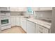 Modern kitchen featuring white cabinets and granite counters at 1673 Nash Ct, Dunedin, FL 34698