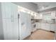 Bright kitchen with white cabinets, granite countertops, and stainless steel appliances at 1673 Nash Ct, Dunedin, FL 34698