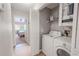 Convenient laundry room with washer, dryer, and extra storage at 1673 Nash Ct, Dunedin, FL 34698