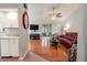 Living room with hardwood floors, recessed lighting and a red reclining sofa at 1673 Nash Ct, Dunedin, FL 34698