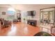 Living room with hardwood floors, wicker chairs, and access to screened patio at 1673 Nash Ct, Dunedin, FL 34698