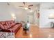 Living room with hardwood floors and a red reclining sofa at 1673 Nash Ct, Dunedin, FL 34698