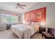Relaxing main bedroom featuring a king bed, ceiling fan, and ample natural light at 1673 Nash Ct, Dunedin, FL 34698