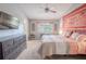 Spacious main bedroom with king-size bed, ceiling fan, and large window at 1673 Nash Ct, Dunedin, FL 34698