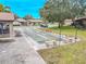 Community shuffleboard court with benches and landscaping at 1673 Nash Ct, Dunedin, FL 34698