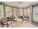 Relaxing sunroom with wicker furniture and view at 1673 Nash Ct, Dunedin, FL 34698
