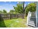 Fenced backyard with grassy area and wooden steps at 2314 E 12Th Ave, Tampa, FL 33605