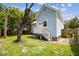 House exterior and fenced backyard with grassy area at 2314 E 12Th Ave, Tampa, FL 33605