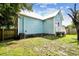 Back of house, fenced yard, and grassy area at 2314 E 12Th Ave, Tampa, FL 33605