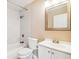 Clean bathroom with white vanity, marble tile, and tub shower combo at 2314 E 12Th Ave, Tampa, FL 33605