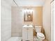 Updated bathroom with a white vanity and tiled shower at 2314 E 12Th Ave, Tampa, FL 33605