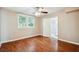 Bright bedroom with wood floors, ceiling fan, and access to bathroom at 2314 E 12Th Ave, Tampa, FL 33605