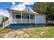 Charming light blue house with a white porch and well-maintained lawn at 2314 E 12Th Ave, Tampa, FL 33605