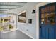 Front porch with a blue door, white railing, and a mailbox at 2314 E 12Th Ave, Tampa, FL 33605