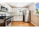Updated kitchen with stainless steel appliances and granite countertops at 2314 E 12Th Ave, Tampa, FL 33605