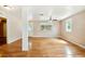Hardwood floor living room with multiple windows and access to other rooms at 2314 E 12Th Ave, Tampa, FL 33605