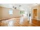 Large living room with wood floors, ceiling fan and access to other rooms at 2314 E 12Th Ave, Tampa, FL 33605