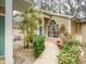 Inviting exterior with a landscaped walkway leading to the front entrance at 2381 Hounds Trl, Palm Harbor, FL 34683