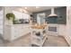 Modern white kitchen with butcher block island and blue tile backsplash at 2963 Sweetgum S Way, Clearwater, FL 33761