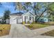 Newly built home with a white exterior, blue accents and landscaping at 3206 E 38Th Ave, Tampa, FL 33610