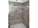 Large walk in shower with grey tile and built-in seat at 3737 Yardarm Dr, Tampa, FL 33611