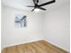 Simple bedroom with light wood floors and ceiling fan at 4215 E Paris St, Tampa, FL 33610