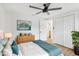 Bright bedroom with wood floors, ceiling fan, and ample closet space at 4215 E Paris St, Tampa, FL 33610
