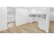 Modern white kitchen with patterned backsplash and quartz countertops at 4215 E Paris St, Tampa, FL 33610