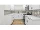 Modern white kitchen with patterned backsplash and new appliances at 4215 E Paris St, Tampa, FL 33610