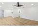 Bright living room with light wood floors and ceiling fan at 4215 E Paris St, Tampa, FL 33610
