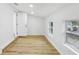 Bright spare bedroom with light wood floors and exterior access at 4215 E Paris St, Tampa, FL 33610