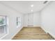 Spacious bedroom with light wood floors and two windows at 4215 E Paris St, Tampa, FL 33610