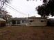 Large backyard with mature trees behind the house at 435 92Nd N Ave, St Petersburg, FL 33702